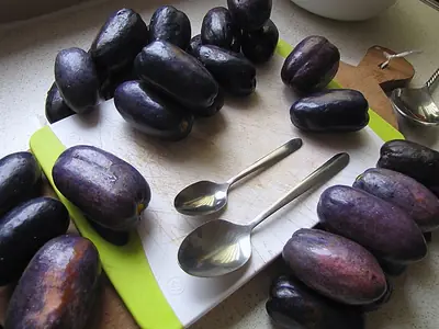 Ripe purple African pears on a chopping board